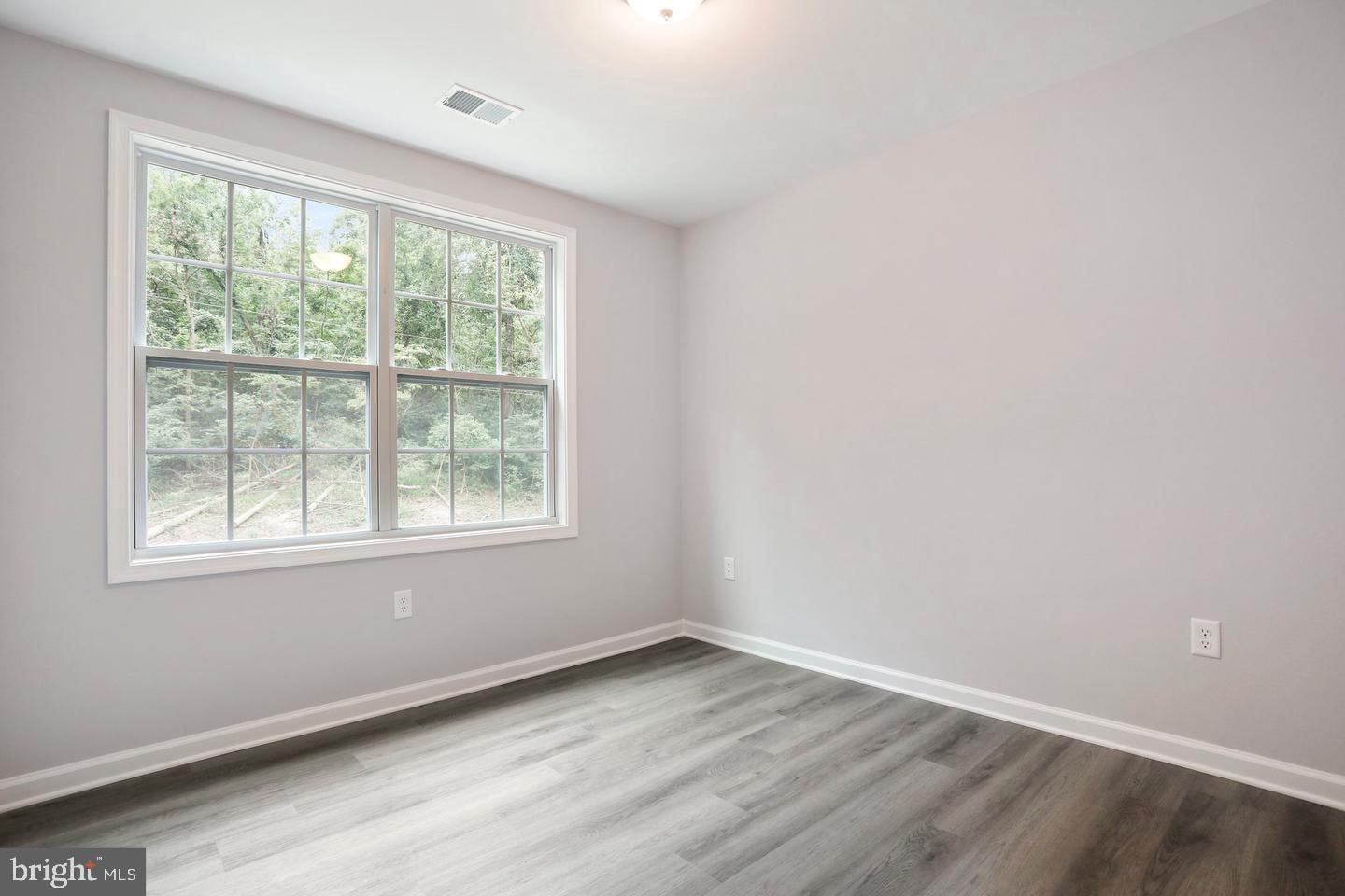 Plum Tree Lane Berkeley Springs, WV 25411 - Photo 15 of 18 an empty room with wooden floor and windows
