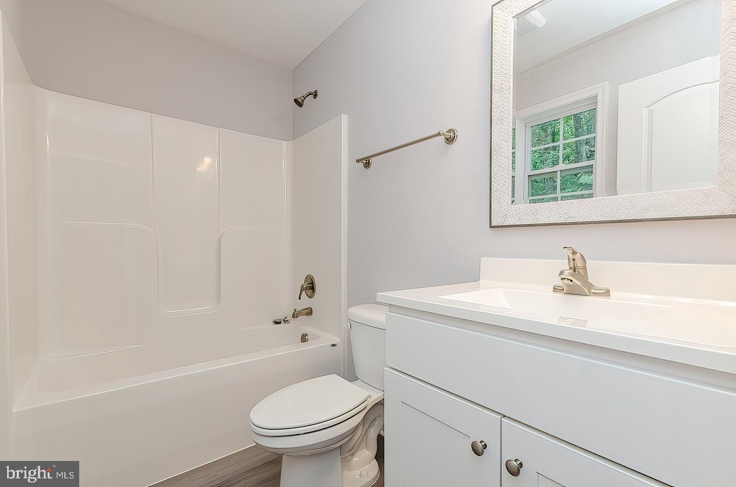 Plum Tree Lane Berkeley Springs, WV 25411 - Photo 10 of 18 a bathroom with a sink a toilet and a bathtub