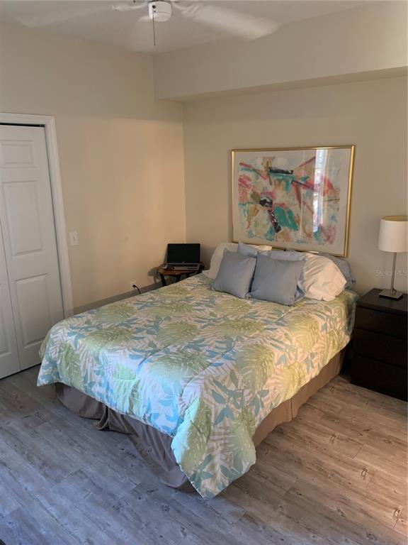 5134 Northridge Road, Unit 204 Sarasota, FL 34238 - Photo 15 of 21 a bedroom with a bed and wooden floor