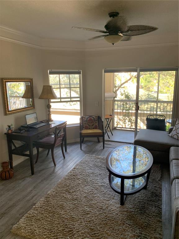 5134 Northridge Road, Unit 204 Sarasota, FL 34238 - Photo 16 of 21 a living room with furniture a table and a large window