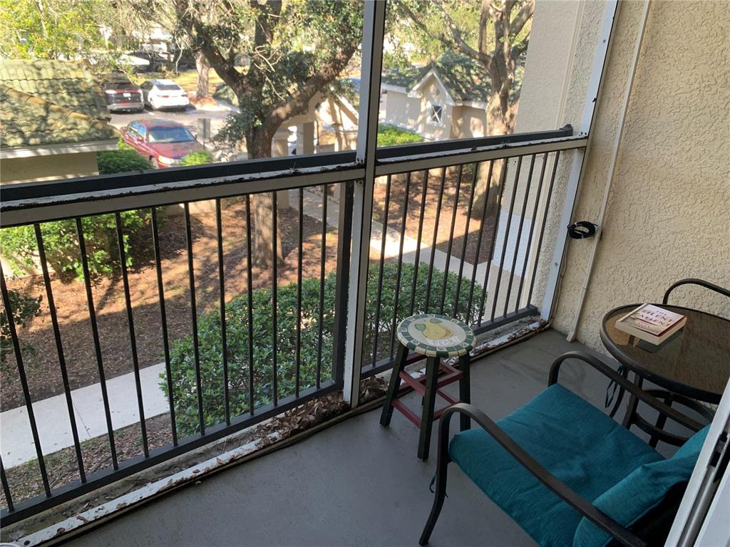 5134 Northridge Road, Unit 204 Sarasota, FL 34238 - Photo 17 of 21 a view of a balcony with chair and wooden floor
