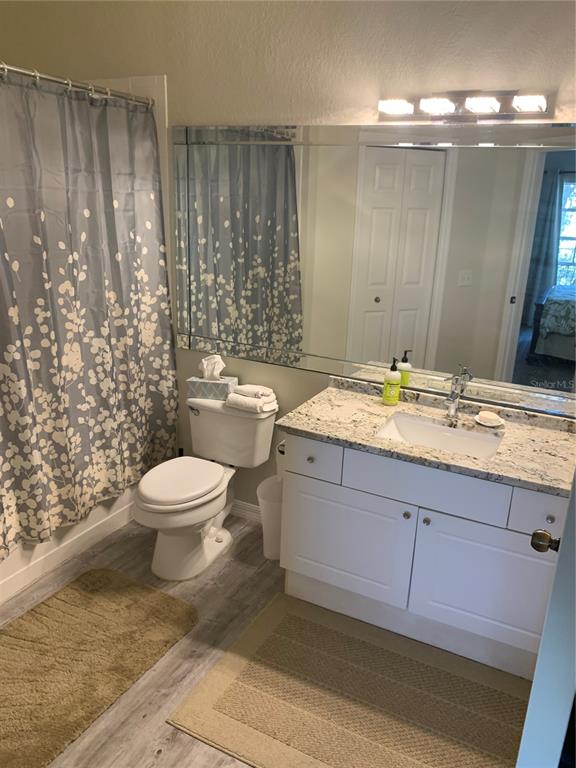 5134 Northridge Road, Unit 204 Sarasota, FL 34238 - Photo 20 of 21 a bathroom with a granite countertop sink toilet and shower