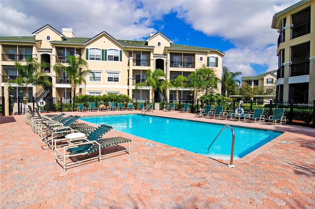 5134 Northridge Road, Unit 204 Sarasota, FL 34238 - Photo 2 of 21 a swimming pool with outdoor seating and yard