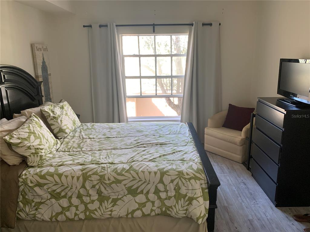 5134 Northridge Road, Unit 204 Sarasota, FL 34238 - Photo 21 of 21 a bedroom with a bed and wooden floor