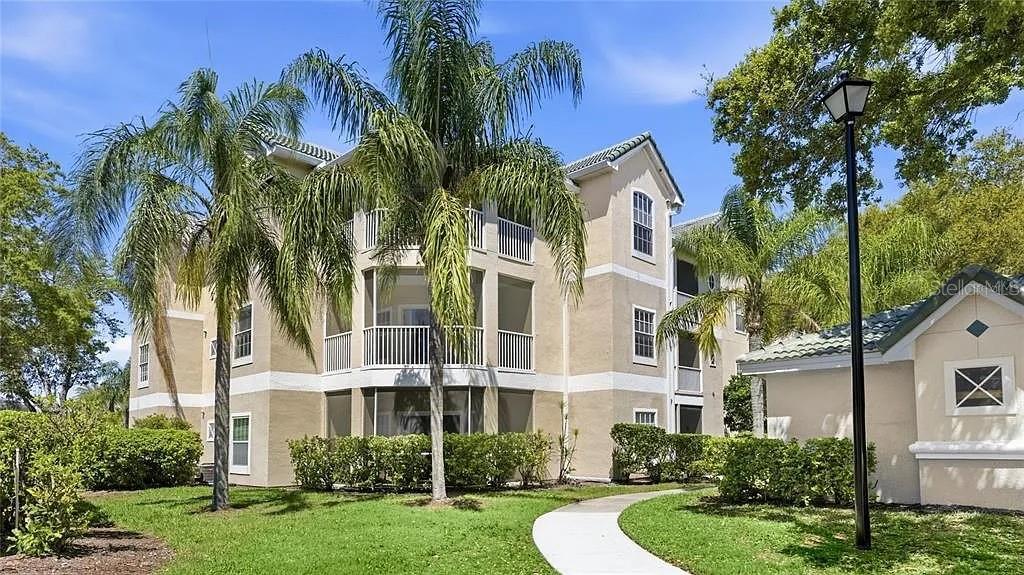 5134 Northridge Road, Unit 204 Sarasota, FL 34238 - Photo 8 of 21 front view of a house with a yard