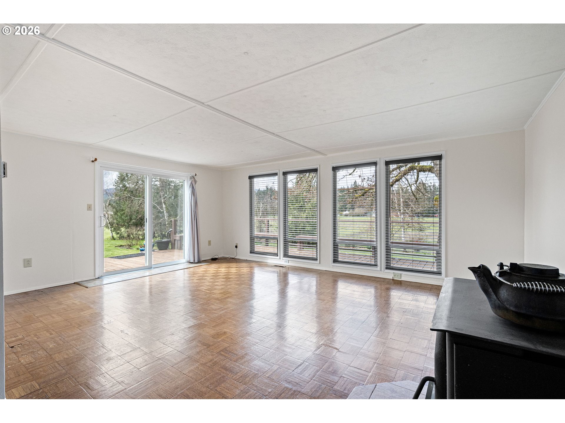 82073 Lost Creek Road Dexter, OR 97431 - Photo 12 of 47 a view of an empty room with wooden floor and a window