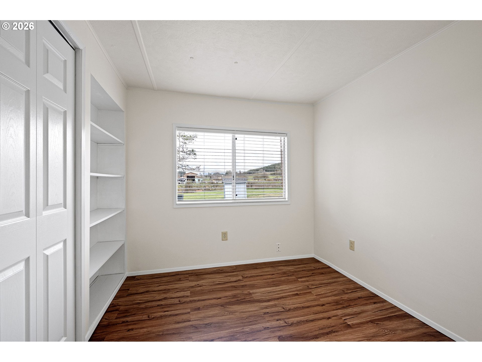 82073 Lost Creek Road Dexter, OR 97431 - Photo 23 of 47 a view of an empty room with wooden floor and a window