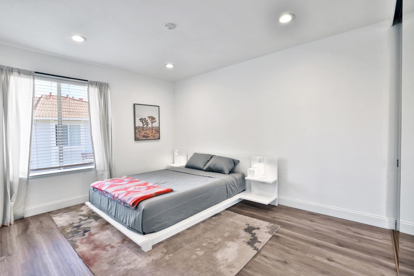 4966 Bridgepointe Place Union City, CA 94587 - Photo 14 of 19 a bedroom with a bed and wooden floor