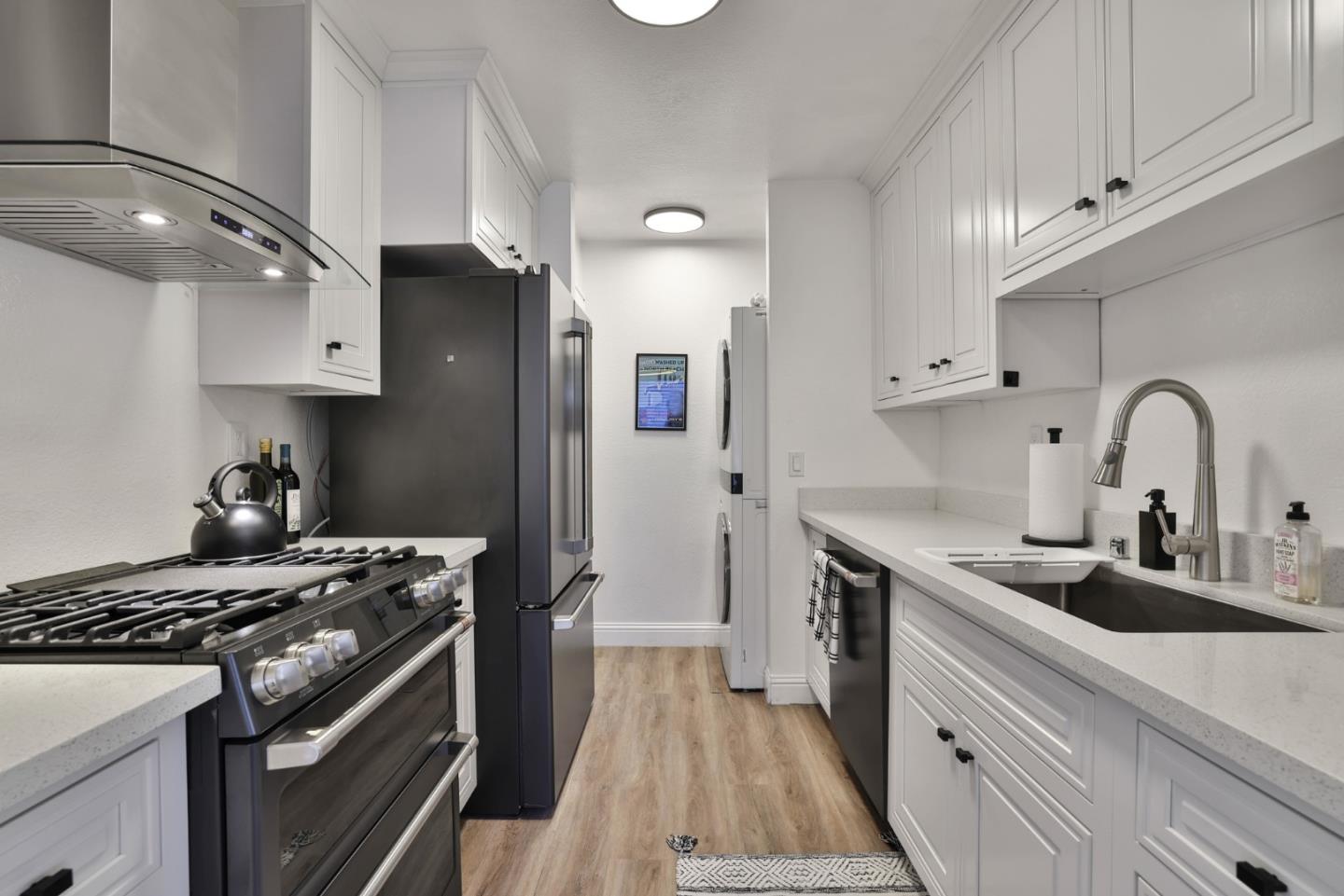 4966 Bridgepointe Place Union City, CA 94587 - Photo 8 of 19 a kitchen with stainless steel appliances granite countertop a sink stove and refrigerator