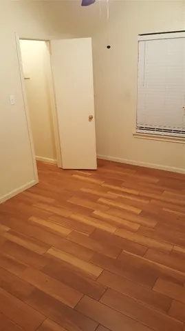 a view of a room with wooden floor