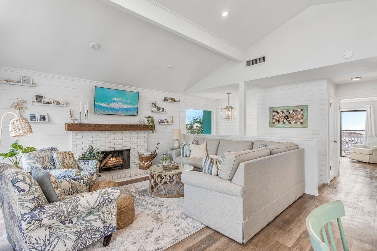 320 Gulf Shore Drive Destin, FL 32541 - Photo 11 of 46 a living room with furniture and a fireplace