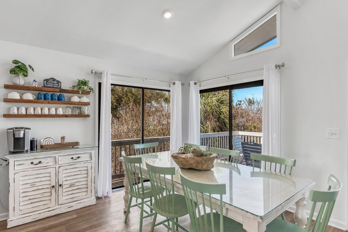 320 Gulf Shore Drive Destin, FL 32541 - Photo 13 of 46 a view of a dining room with furniture a rug and wooden floor