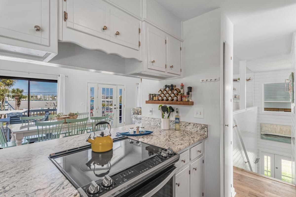 320 Gulf Shore Drive Destin, FL 32541 - Photo 14 of 46 a kitchen with a table and chairs in it
