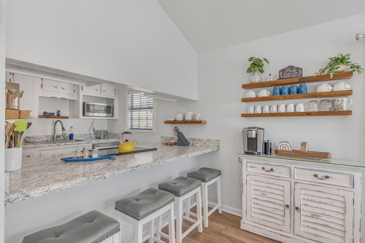 320 Gulf Shore Drive Destin, FL 32541 - Photo 16 of 46 a kitchen with a sink a stove and cabinets