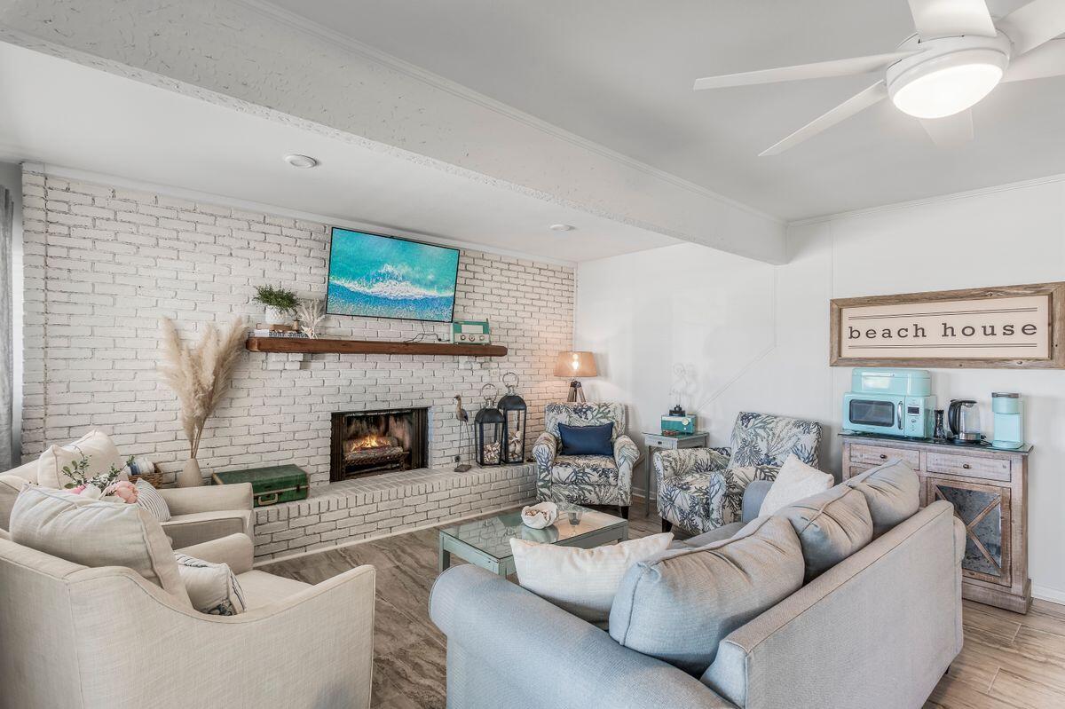 320 Gulf Shore Drive Destin, FL 32541 - Photo 25 of 46 a living room with furniture a fireplace and a large window