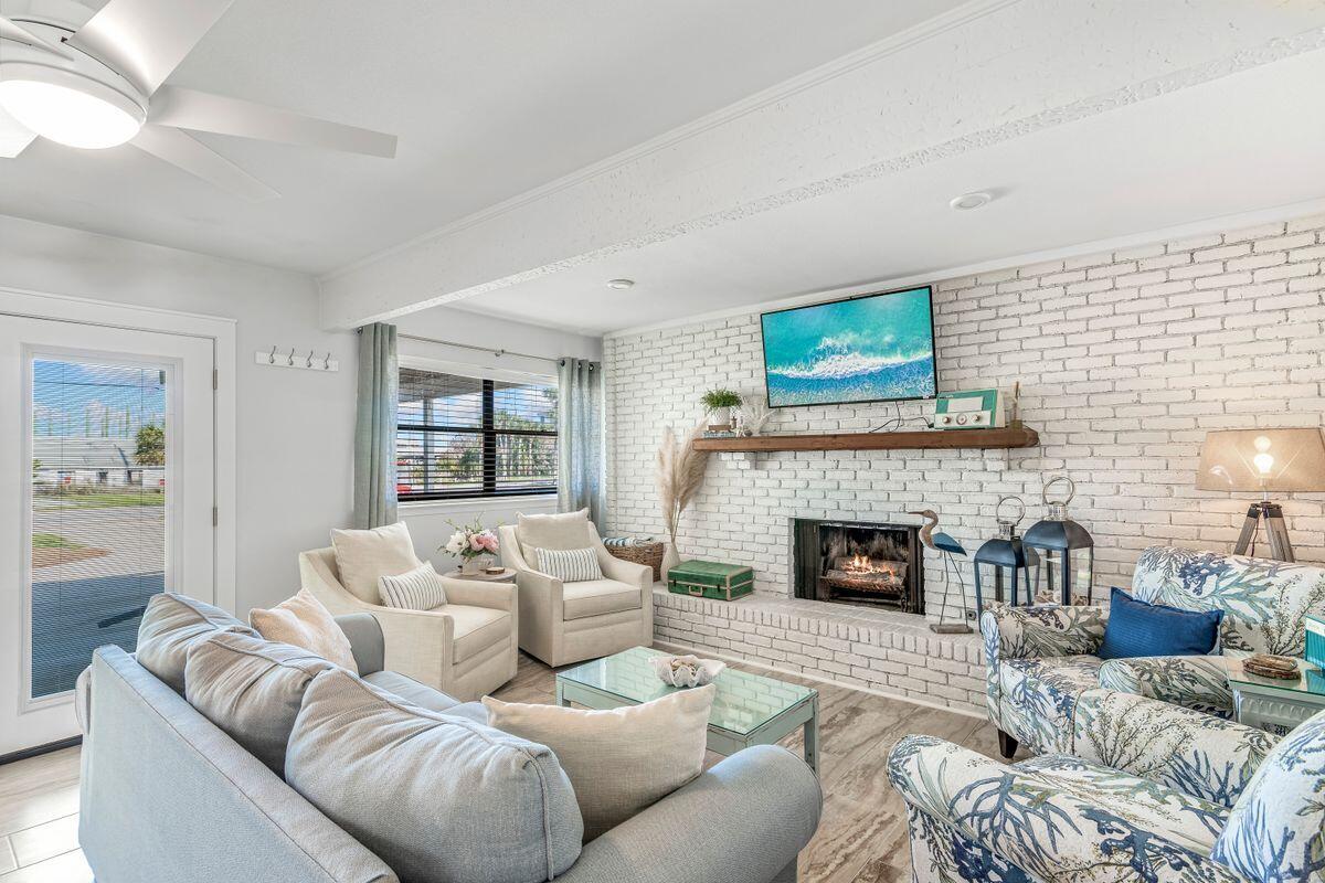 320 Gulf Shore Drive Destin, FL 32541 - Photo 27 of 46 a living room with furniture and a fireplace