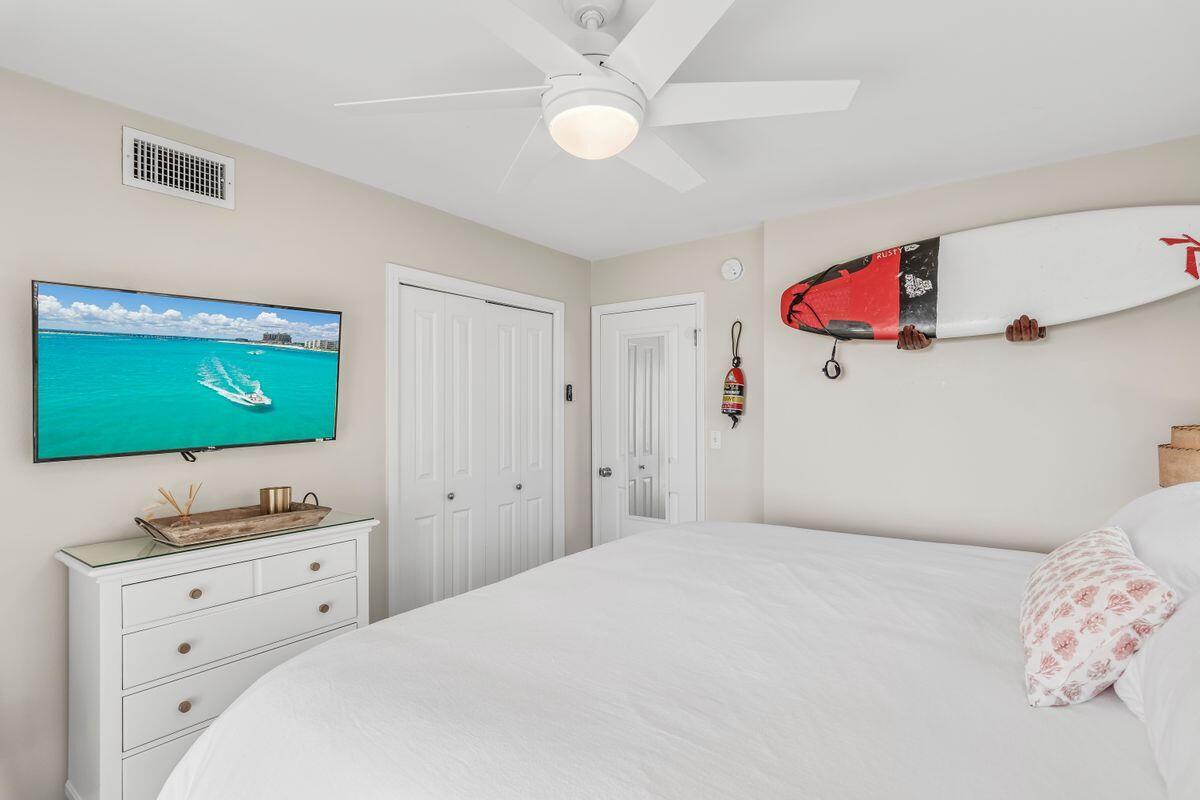 320 Gulf Shore Drive Destin, FL 32541 - Photo 30 of 46 a bedroom with a bed and a flat screen tv