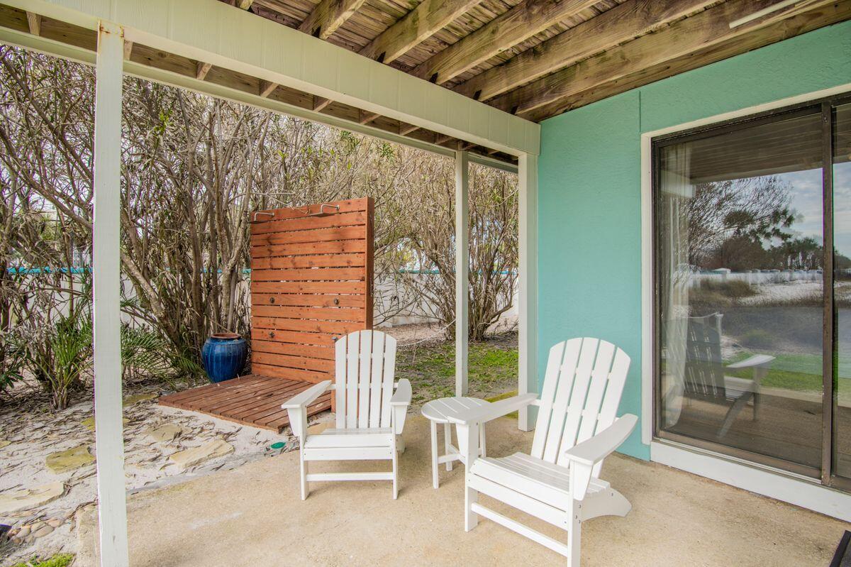 320 Gulf Shore Drive Destin, FL 32541 - Photo 33 of 46 a view of a porch with a table and chairs