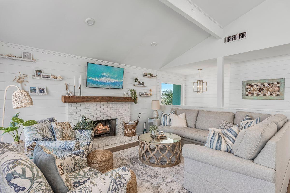 320 Gulf Shore Drive Destin, FL 32541 - Photo 10 of 46 a living room with furniture and a fireplace