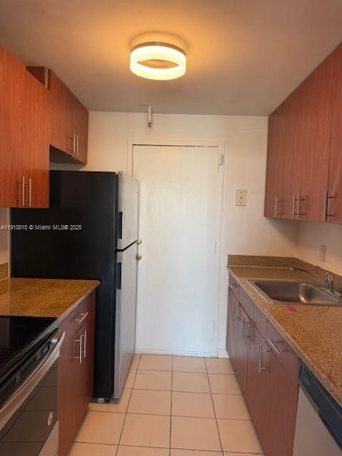 2350 Northeast 135th Street, Unit 711 North Miami, FL 33181 - Photo 3 of 10 a kitchen with a refrigerator and a sink