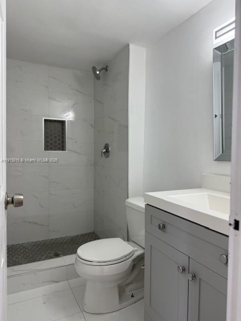 2350 Northeast 135th Street, Unit 711 North Miami, FL 33181 - Photo 6 of 10 a bathroom with a sink a toilet and shower
