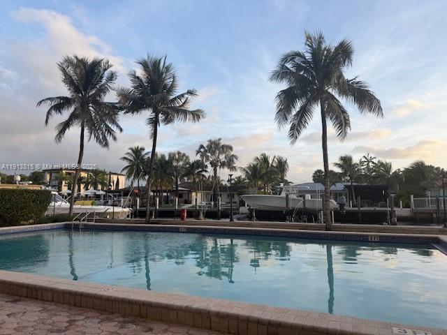 2350 Northeast 135th Street, Unit 711 North Miami, FL 33181 - Photo 10 of 10 a view of swimming pool with a table and chairs