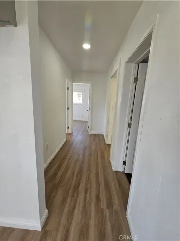 a view of a room with wooden floor and staircase