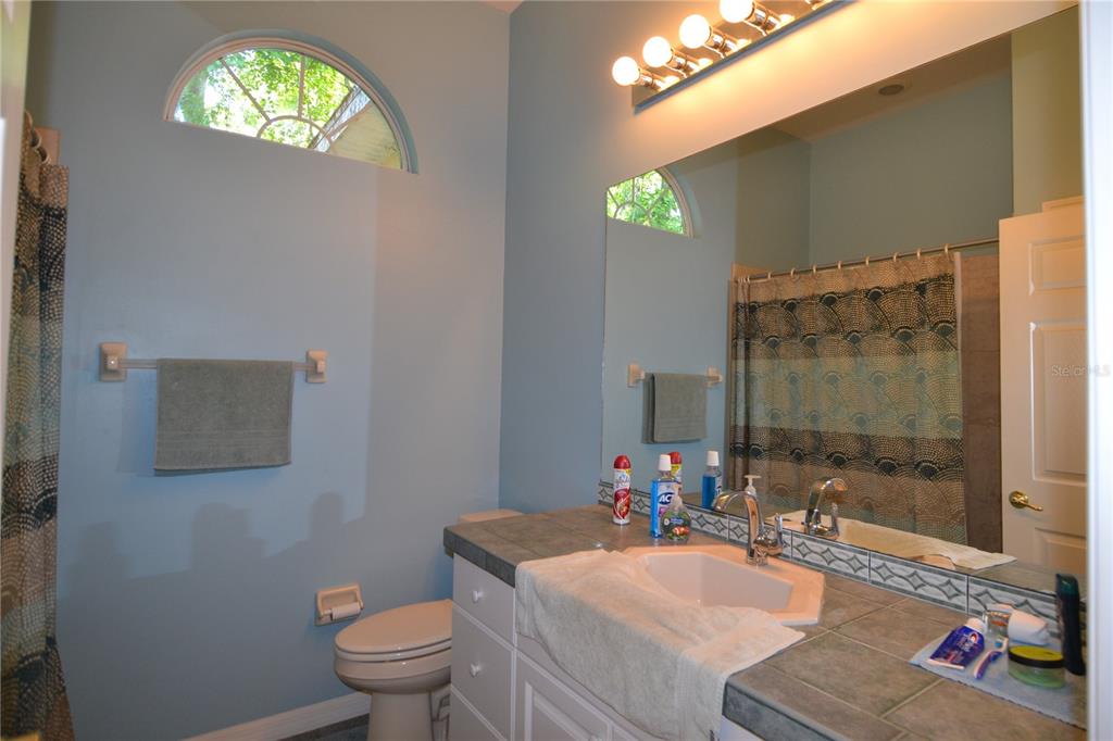 79 Northwest 48th Boulevard Gainesville, FL 32607 - Photo 14 of 30 a bathroom with a sink toilet and shower