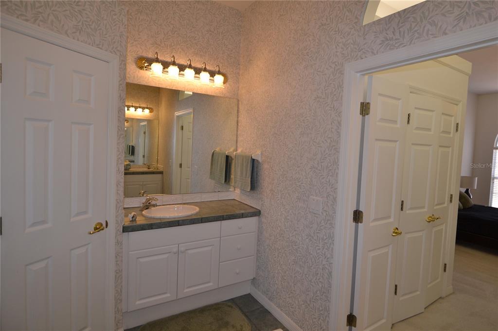 79 Northwest 48th Boulevard Gainesville, FL 32607 - Photo 17 of 30 a bathroom with a granite countertop sink a mirror and shower