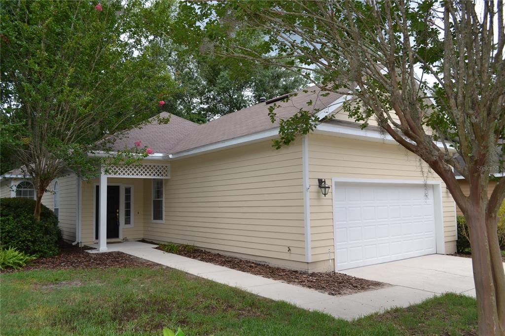 79 Northwest 48th Boulevard Gainesville, FL 32607 - Photo 2 of 30 a view of a white house next to a yard with a large tree