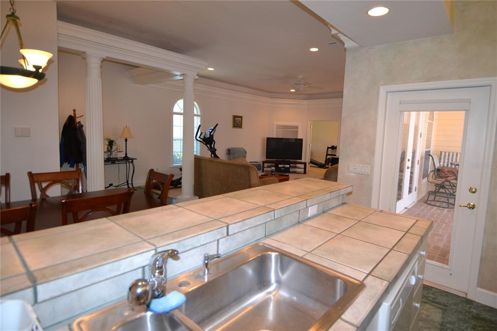 79 Northwest 48th Boulevard Gainesville, FL 32607 - Photo 6 of 30 a room with kitchen island stainless steel appliances wooden floor dining table and chairs