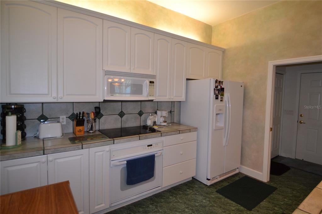 79 Northwest 48th Boulevard Gainesville, FL 32607 - Photo 7 of 30 a kitchen with stainless steel appliances granite countertop a sink stove and cabinets