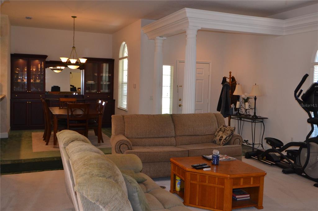 79 Northwest 48th Boulevard Gainesville, FL 32607 - Photo 8 of 30 a living room with furniture a dining table and a chandelier