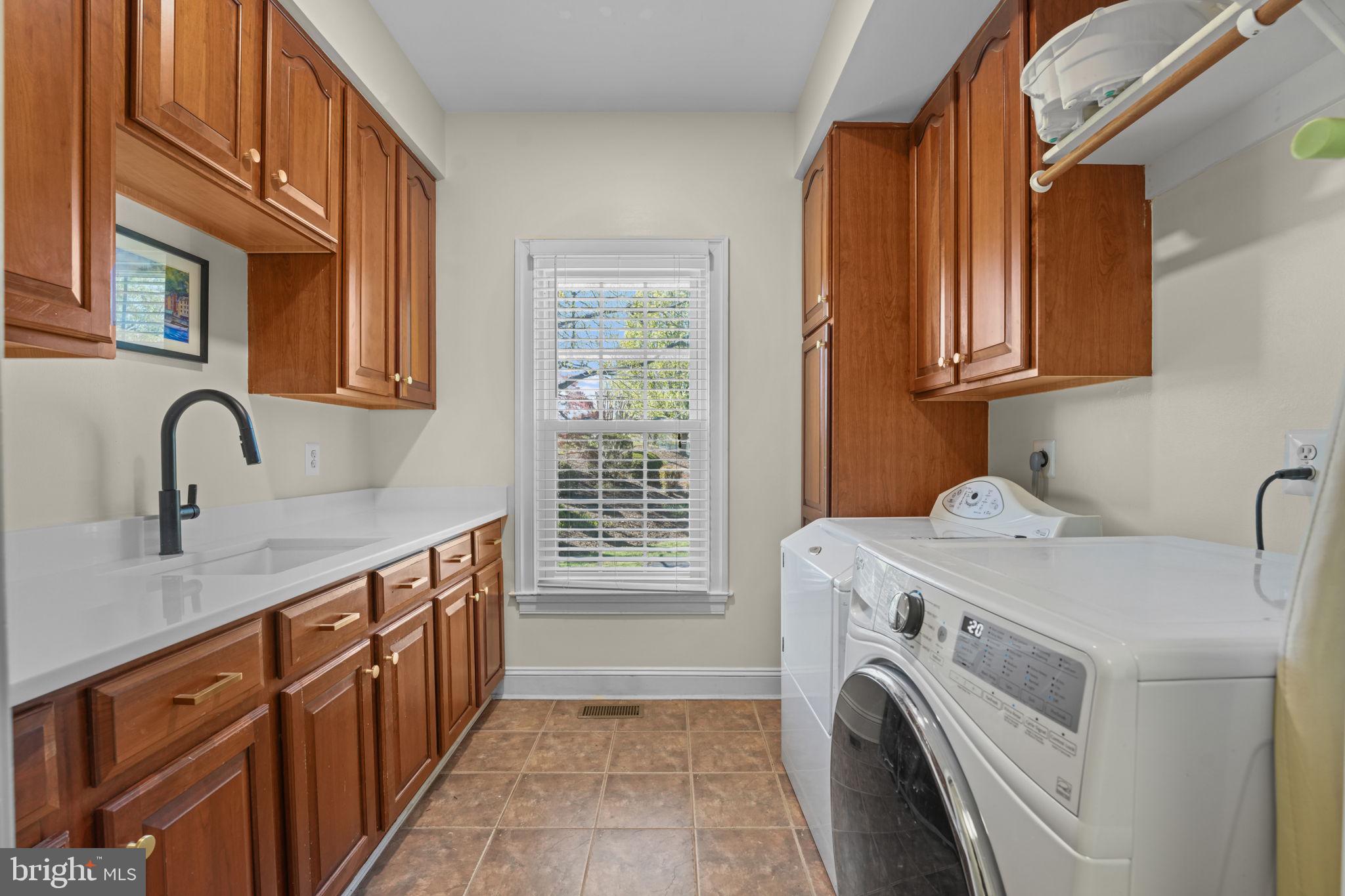 11431 Woolington Road Great Falls, VA 22066 - Photo 20 of 49 a utility room with sink dryer and washer