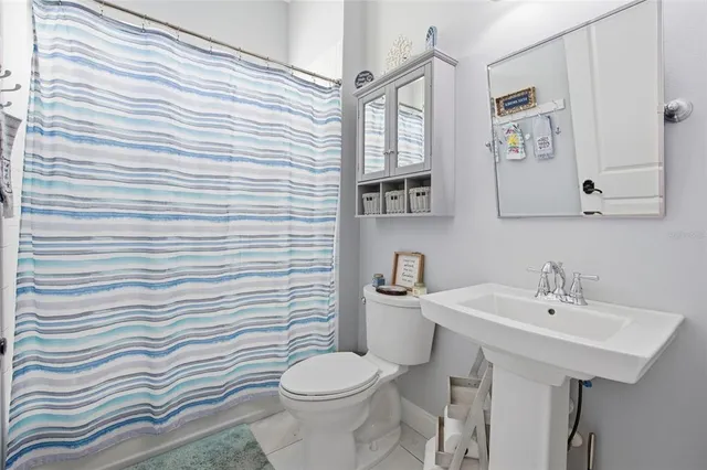 a bathroom with a sink a toilet and mirror