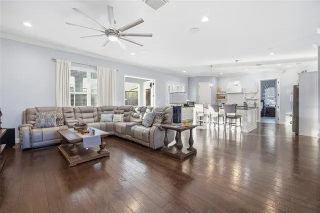 a living room with furniture and wooden floor
