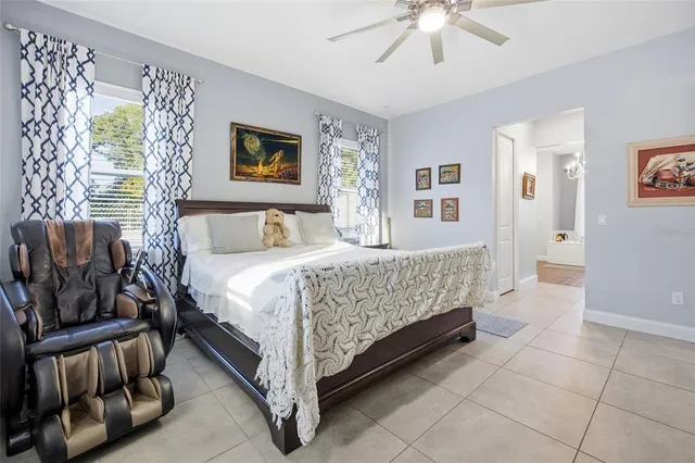 a bedroom with a bed and a chandelier