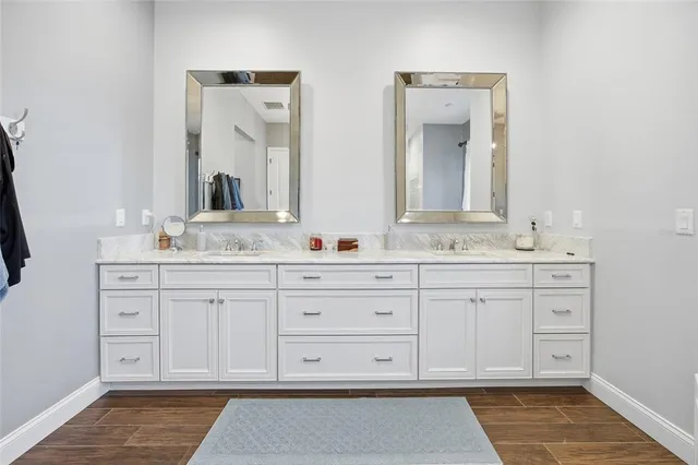 a bathroom with a sink vanity and mirror