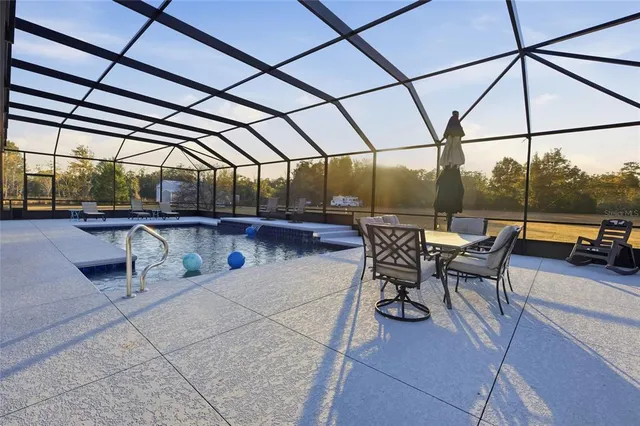 a view of a swimming pool with a lounge chair
