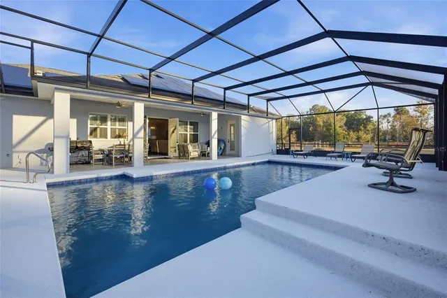 a view of a swimming pool with outdoor seating
