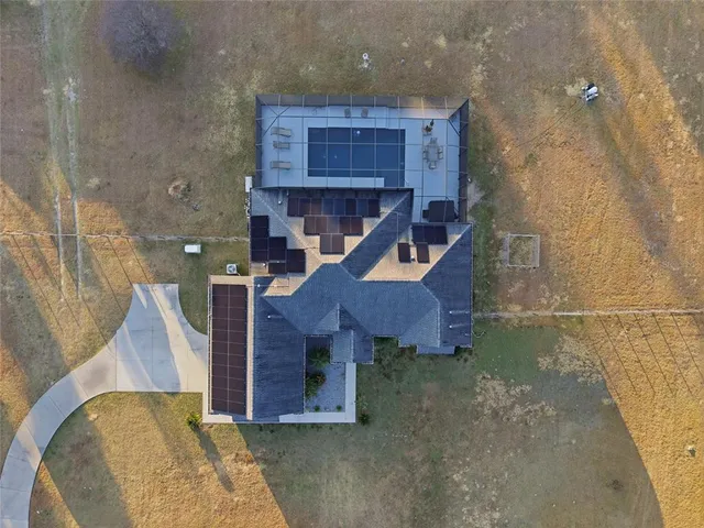 an aerial view of a houses with a yard
