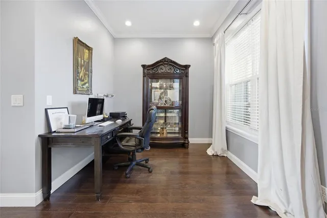 a workspace with wooden floor and a window
