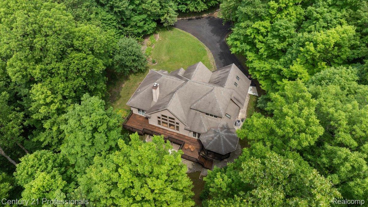 9867 Rainbow Ridge Drive Schoolcraft, MI 49087 - Photo 67 of 82 Wooded property featuring a multi-level residence with a gray shingle roof, a wraparound deck, and an integrated octagonal gazebo