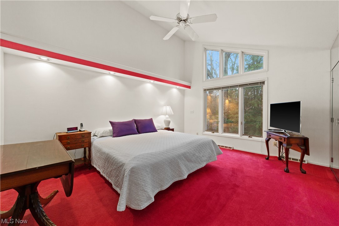 3845 Lander Road, Unit 2 Chagrin Falls, OH 44022 - Photo 21 of 31 Bedroom featuring ceiling fan, carpet, and high vaulted ceiling