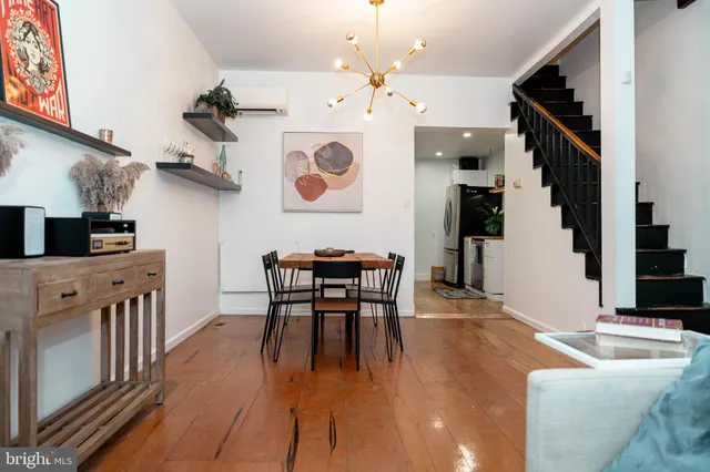 a dining room with furniture and wooden floor