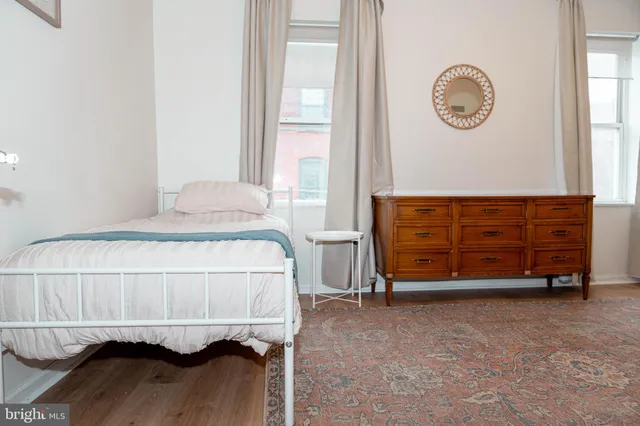 a bedroom with a bed a table and chair