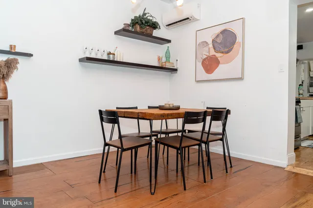 a dining room with furniture and wooden floor