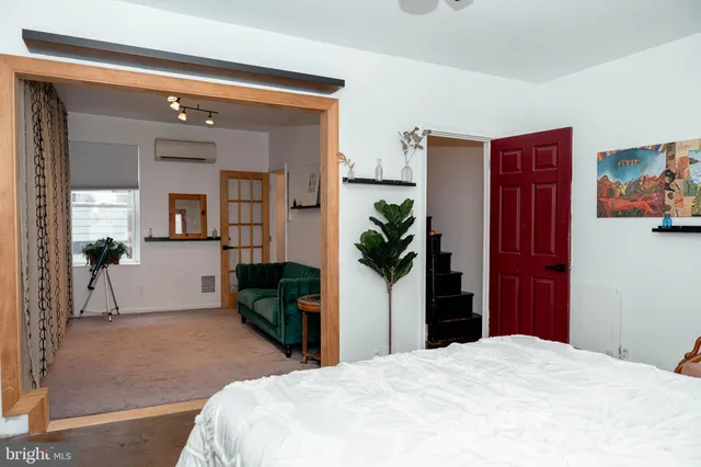 a bedroom with a bed and a window