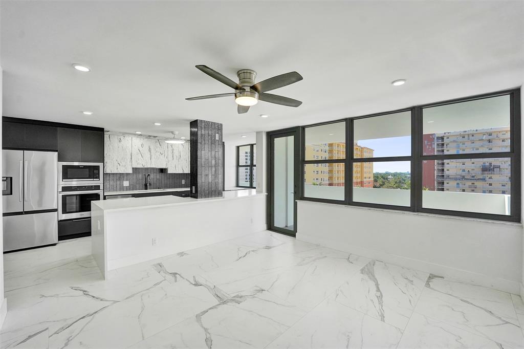 1390 South Ocean Boulevard, Unit 5C Pompano Beach, FL 33062 - Photo 14 of 35 a large white kitchen with a large window appliances and furniture