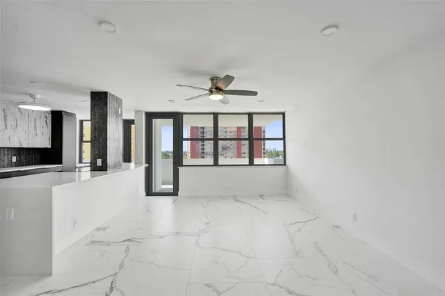 a large kitchen with stainless steel appliances a refrigerator and a stove top oven